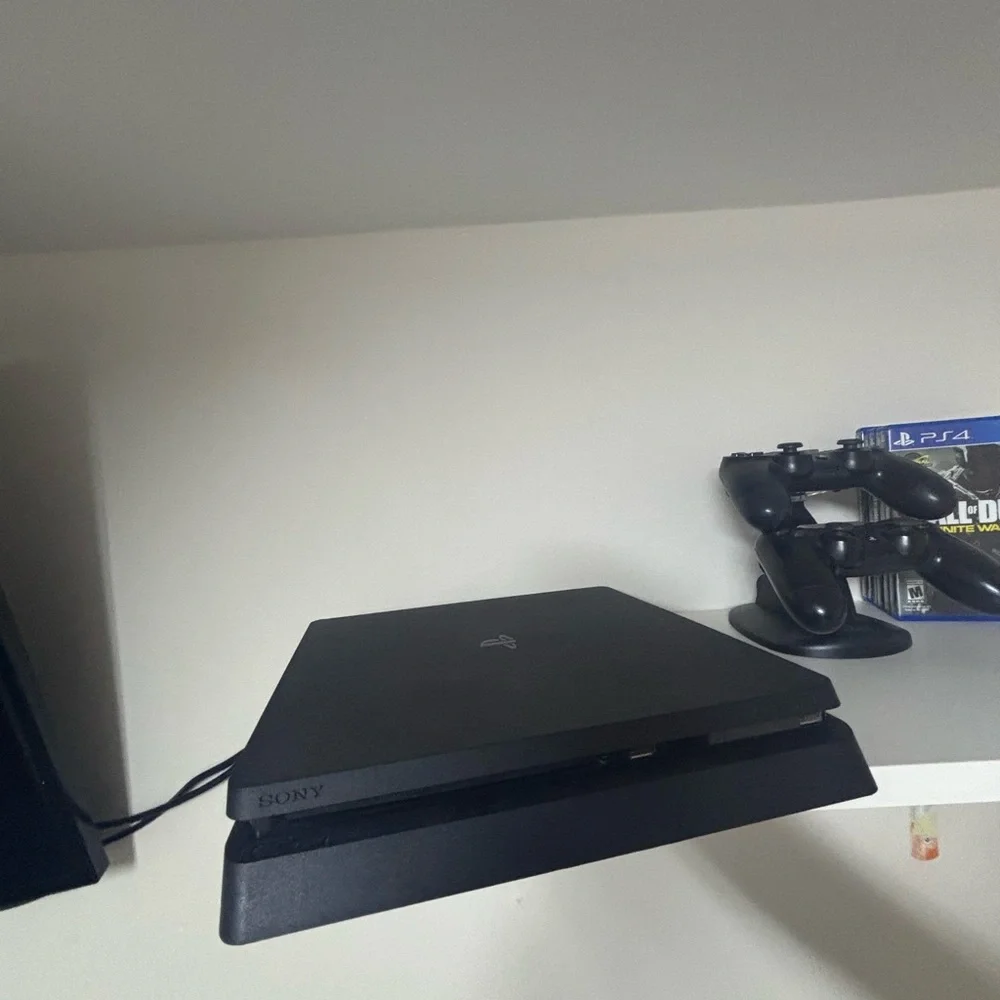 Sony PlayStation Console with DualShock Controllers - Black Like new